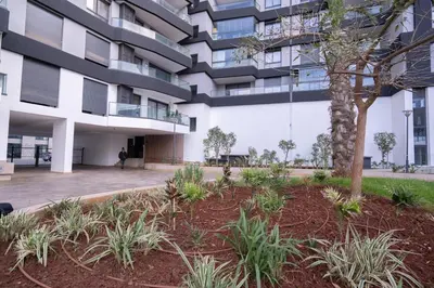 an apartment building with a courtyard with a tree at Appartement de haut standing au centre ville in Casablanca