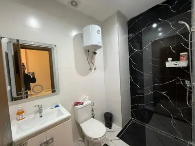a bathroom with a toilet and a sink and a mirror at Studio cosy connecté in Casablanca