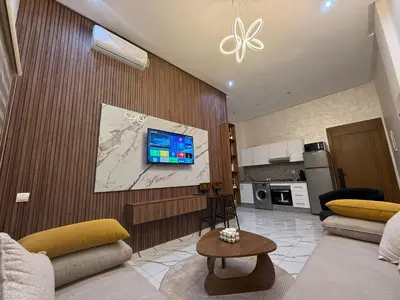 a living room with a couch and a tv on a wall at Studio cosy connecté in Casablanca
