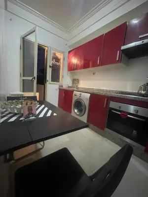 a kitchen with red cabinets and a washing machine at Avenue cimetière bourgogne Casablanca in Casablanca