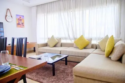 a living room with two couches and a table at Luxueux studio spacieux à racine Casablanca à une minute de twin center in Casablanca