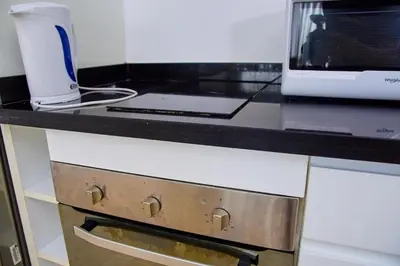 a kitchen counter with a microwave and a drawer at Luxueux studio spacieux à racine Casablanca à une minute de twin center in Casablanca