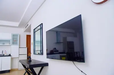 a large flat screen tv hanging on a wall at Luxueux studio spacieux à racine Casablanca à une minute de twin center in Casablanca
