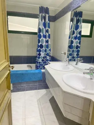 a bathroom with two sinks and a tub at Residence kheir in Casablanca