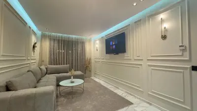 a living room with a couch and a tv at Suite luxueuse proche de Cheikh Zayed & CFC in Casablanca
