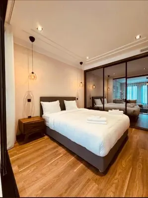 a bedroom with a large white bed and a couch at Les Joyeux Luxury Studios et Suites in Casablanca