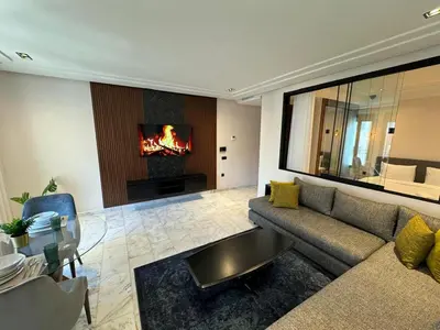 a living room with a couch and a fireplace at Les Joyeux Luxury Studios et Suites in Casablanca