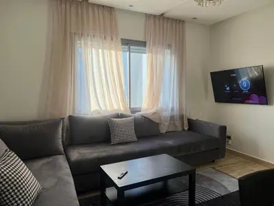 a living room with a couch and a window at Appartement centre de casablanca in Casablanca