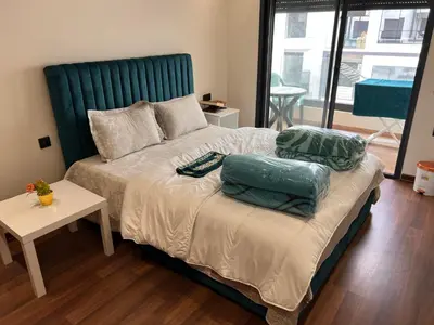 a bed with two pillows on it in a bedroom at Studio de luxe in Casablanca