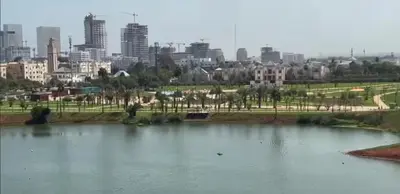 a large pond of water with a city in the background at Studio de luxe in Casablanca