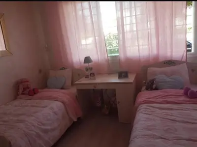 a bedroom with two beds and a desk and window at Rabat prestigia hayriad in Rabat