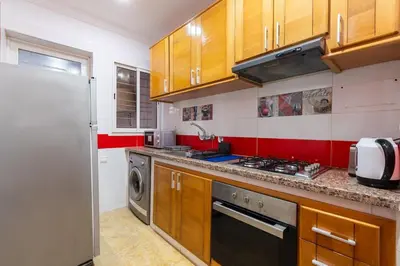 a kitchen with a refrigerator and a dishwasher at Prestige Penthouse Style and Serenity Rabat by MERAT HOME in Rabat