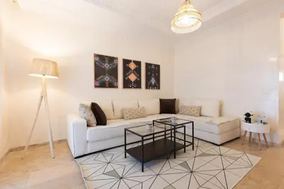 a living room with a white couch and a table at Prestige Penthouse Style and Serenity Rabat by MERAT HOME in Rabat