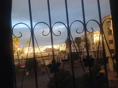 a view of a city from a window with a fence at Spacious apartment in Settat