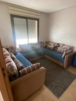 a living room with a blue couch and a window at Rock island sablette in Pont Blondin