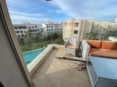 a balcony with a view of a swimming pool at Rock island sablette in Pont Blondin