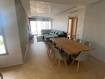 a dining room with a table and chairs and a couch at Rock island sablette in Pont Blondin