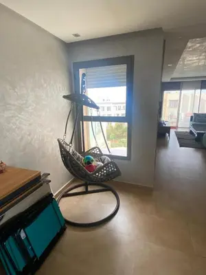 a hammock chair sitting in a living room with a window at Rock island sablette in Pont Blondin