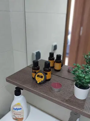 four bottles of honey sitting on a shelf in a bathroom at Charming Flat with Pool view Fast Wi-Fi in Bouznika