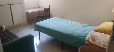 a bedroom with a bed and a desk and a chair at budget holidays room in Casablanca