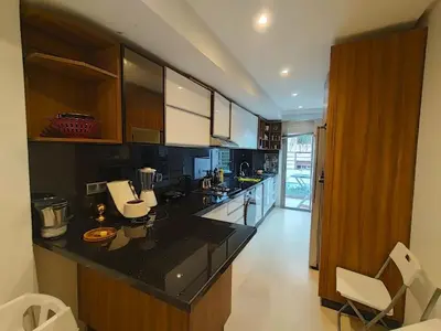 a kitchen with a black counter top and wooden cabinets at Joli appartement au centre-ville de Rabat in Rabat
