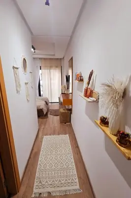 a hallway with a room with a bed and a white rug at Cosy Appartement Rabat Agdal in Rabat