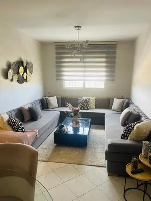 a living room with a couch and a table at Jannat tamaris in Tamaris