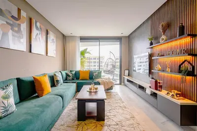 a living room with a green couch and a table at Urban Chic Suite Casablanca city centre - Parking Gym in Casablanca