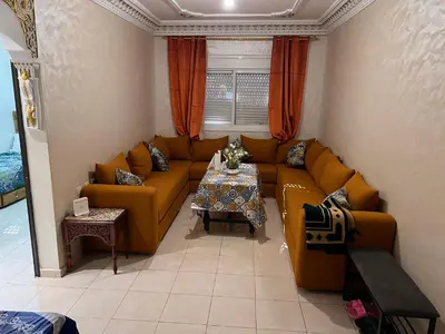 a living room with a couch and a table at Appartement de luxe in Casablanca