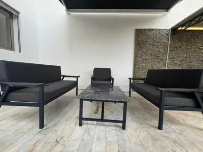 two black chairs and a table in a room at RÉSIDENCE LE BIjOU DE L'AGDAL in Rabat
