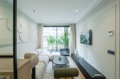 a living room with a couch and a table at Résidence Claridge Racine in Casablanca