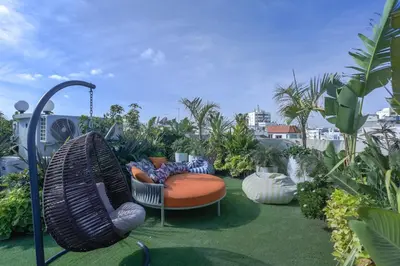 a garden with two chairs and a swing at Résidence Claridge Racine in Casablanca