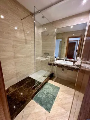 a bathroom with a shower and a sink and a mirror at Peninsula Dar Bouazza in Tamaris