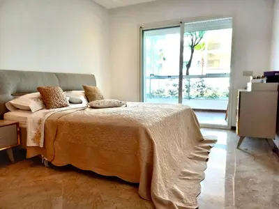 a bedroom with a bed and a large window at Peninsula Dar Bouazza in Tamaris