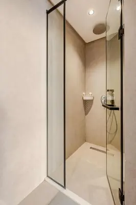 a shower with a glass door in a bathroom at Appartement de luxe - Les Princesses avec Parking in Casablanca