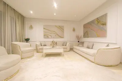 a living room with white couches and a table at 165m luxury Family apartment in prestigia rabat in Rabat