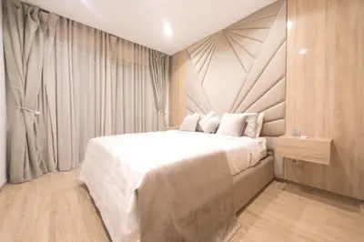 a bedroom with a large bed with white sheets and pillows at 165m luxury Family apartment in prestigia rabat in Rabat