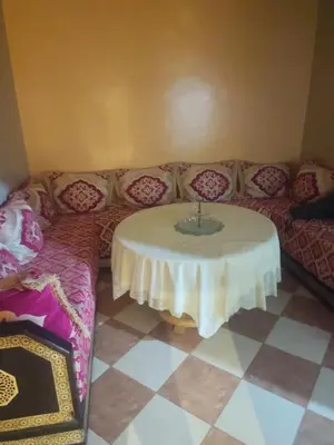 a living room with a table and a couch at Big family house sohofi in Casablanca