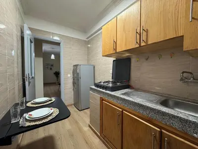a kitchen with a sink and a refrigerator at super studio vue sur mer pour les familles in Rabat