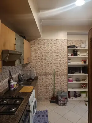 a kitchen with a sink and a stove top oven at Appartement a belvédère in Casablanca