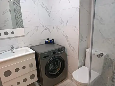 a bathroom with a washing machine and a sink at Bati d or in Mohammedia