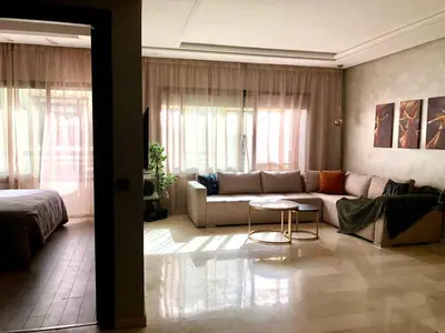 a living room with a couch and a bed at Cosy C35 in Casablanca