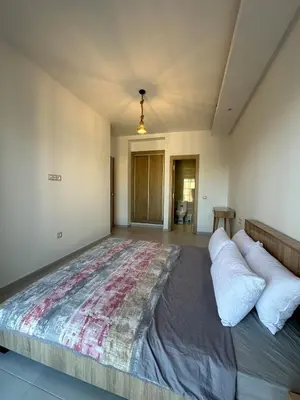 a bedroom with a large bed with pillows on it at Bel Appartement à Harhoura pour les familles in El Harhoura