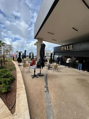 a group of people sitting in chairs outside of a building at L'Appart du Carousel in Rabat