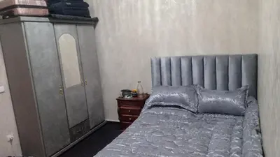 a bedroom with a bed and a dresser and a mirror at confy house in Casablanca