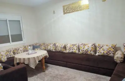 a living room with a brown couch and a table at confy house in Casablanca