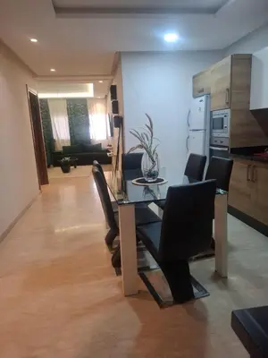 a dining table and chairs in a living room at Luxury studio 20 in Casablanca