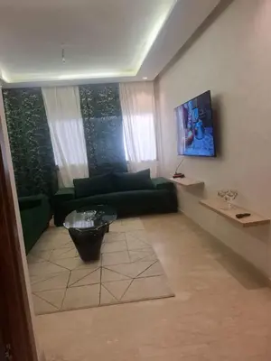 a living room with a green couch and a table at Luxury studio 20 in Casablanca