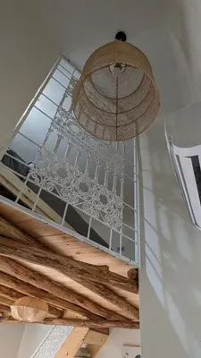 a chandelier hanging from a ceiling in a room at Appt neuf Zenata- 2 chambres et Mezzanine - Piscine in Aïn Harrouda