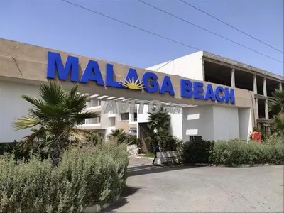 a malaya beach building with a sign on it at Appartement ALAA - Malaga beach in Mansouria